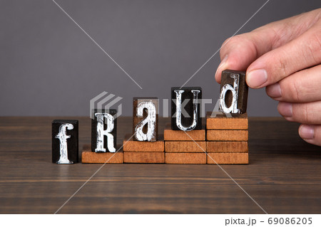 FRAUD concept. Wooden alphabet letters on steps 69086205