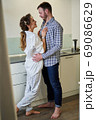 Loving married couple looking at each other at home 69086629