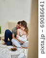 Husband hugs his beloved wife at home. 69086641