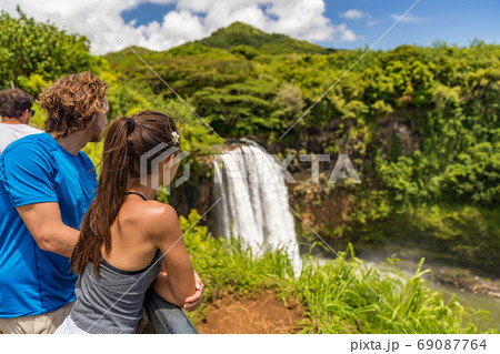 Couple tourists at Hawaii Kauai waterfall 69087764
