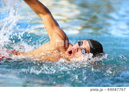 Man swimmer swimming crawl in blue ocean water 69087767