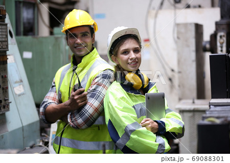 engineer at work, Portrait of male and female Engineer standing with confident against machine environment in factory, Engineers operating a machine in factory 69088301