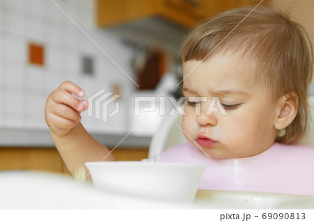 portrait of a child who smeared face with food portrait of a child who smeared face with food 69090813