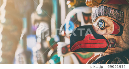 Alaska totem pole in Ketchichan town, cruise travel autumn destination for USA. Wooden post hand carved bird native art panoramic banner. Alaska totem pole in Ketchichan town, cruise travel autumn destination for USA. Wooden post hand carved bird native art panoramic banner. 69091953