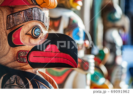 Alaska totem pole carving art sculture store in tourist travel attraction town on Alaska cruise. Ketchikan, Juneau, Skagway stores and shops selling native paintings and art. 69091962