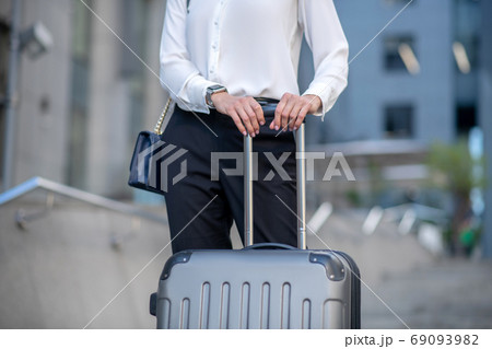 Close up picture of a woman with a suitcase Close up picture of a woman with a suitcase 69093982
