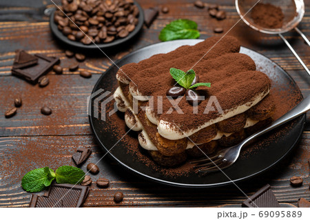 Classic tiramisu dessert on ceramic plate on wooden background 69095889