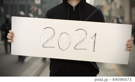 Handwritten 2021 text on an activism banner Handwritten 2021 text on an activism banner 69096073