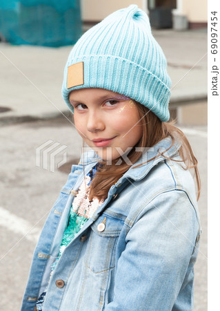 Little girl in light blue hat and jeans jacket Little girl in light blue hat and jeans jacket 69097454