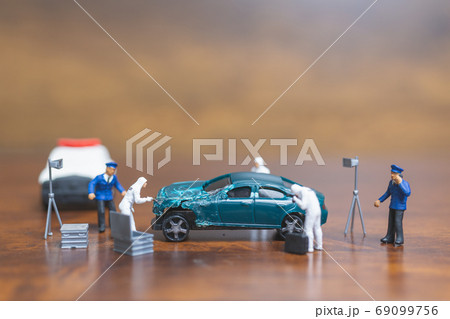 Miniature people Police And Detective standing in front of car Miniature people Police And Detective standing in front of car 69099756