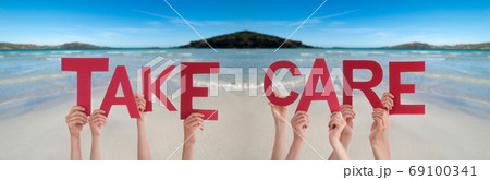 People Hands Holding Word Take Care, Ocean Background People Hands Holding Word Take Care, Ocean Background 69100341