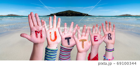 Children Hands Building Word Mutter Means Mother, Ocean Background Children Hands Building Word Mutter Means Mother, Ocean Background 69100344