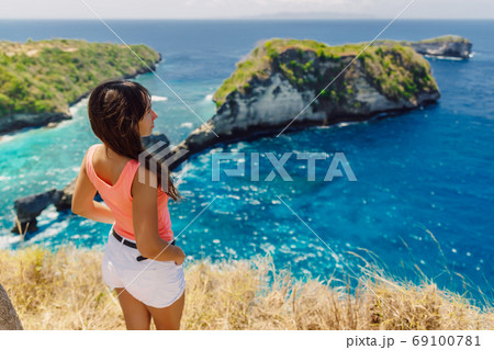Young traveller woman posing at Atuh beach on Nusa Penida island, Indonesia 69100781