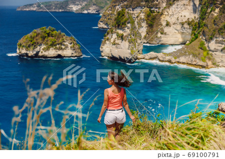Young traveller woman posing at Atuh beach on Nusa Penida island, Indonesia 69100791