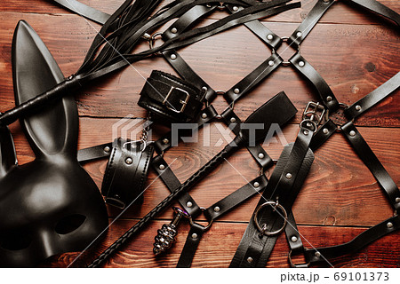 set of sex toys for hard BDSM sex with domination and submission. Leather whip, handcuffs, belt 69101373