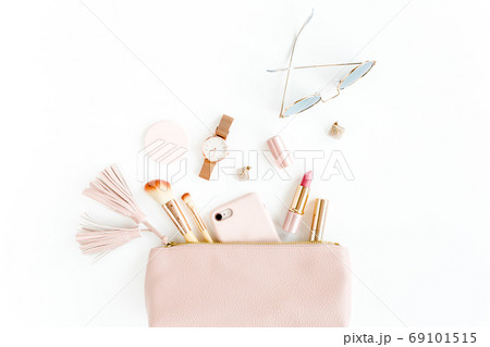 Flat lay composition with pink cosmetic bag with cosmetic makeup products, isolated on white background. Flat lay, top view. 69101515