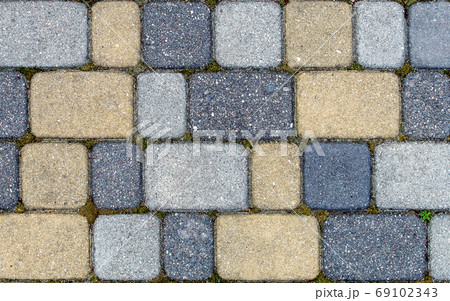 road paved with sidewalk tiles. texture of yellow, light and dar 69102343