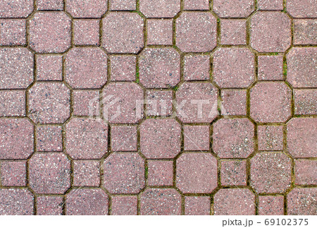 road paved with brown sidewalk tiles. texture of light brown bri road paved with brown sidewalk tiles. texture of light brown bri 69102375