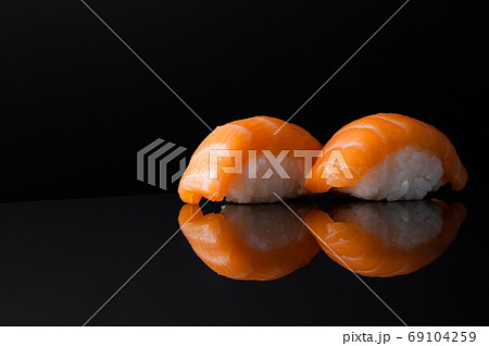 closeup of sushi with rice on black background with reflection closeup of sushi with rice on black background with reflection 69104259