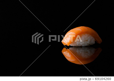 close-up of sushi with rice on black background with reflection close-up of sushi with rice on black background with reflection 69104260