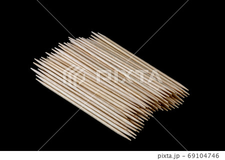 Pile of Wooden Toothpicks on a Black Background 69104746