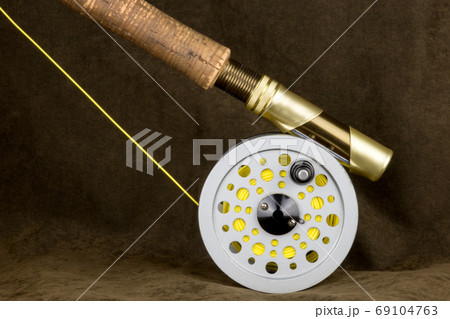 Fly Fishing Rod Line and Reel on Outdoor Coat - Stock Photo
