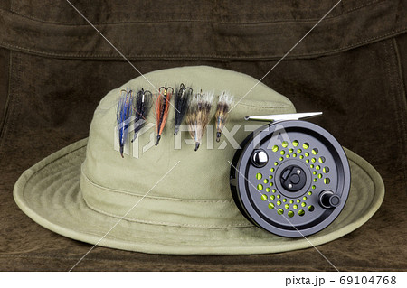 Fishing Flies on Hat with Fly Fishing Reel on Outdoor Coat 69104768