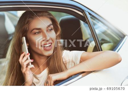 Handsome woman sitting in a car. 69105670