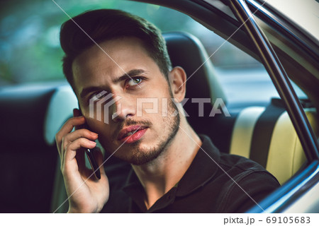 Passenger businessman use a smartphone in the back 69105683
