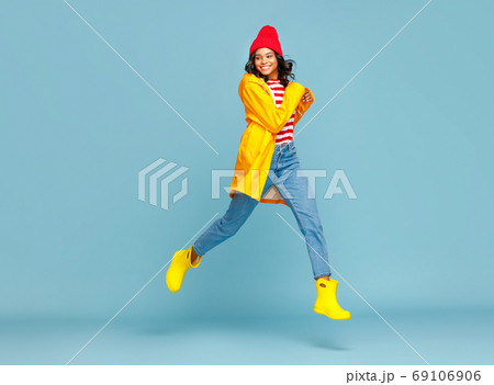 Happy ethnic female kicking air. 69106906