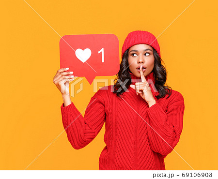 Ethnic woman sharing secret in social media. 69106908