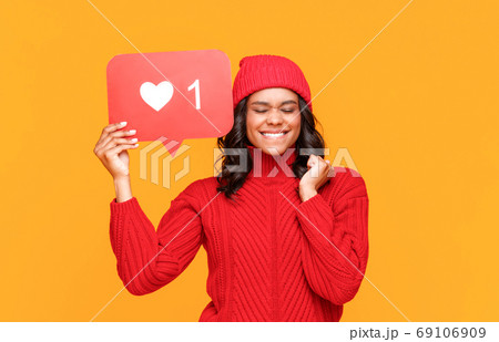 Ethnic female making wish in social media. 69106909