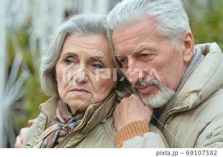 Portrait of sad thoughtful senior couple in park 69107582