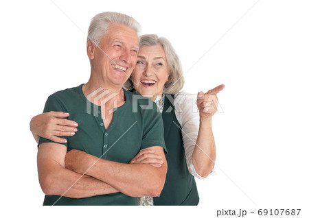 Portrait of a happy senior couple pointing to the right 69107687