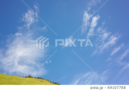 green grassland under blue sky 69107768