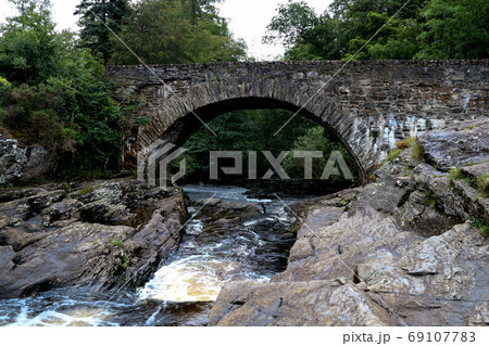 Highland River and Old Stone Bridge in Scotland 69107783