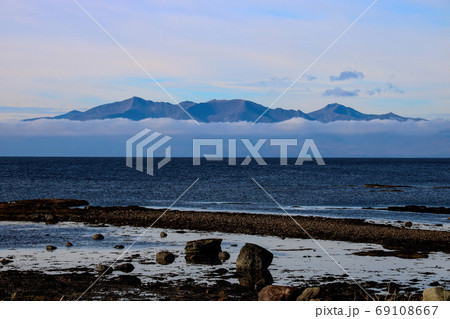 Isle of Arran Emerging from Low Cloud from Seamill Beach Scotlan Isle of Arran Emerging from Low Cloud from Seamill Beach Scotlan 69108667