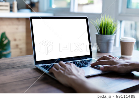 mock up businessman working empty screen computer on wood desk in home 69111489
