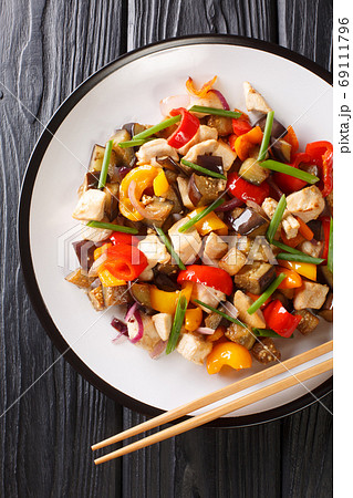 stir-fried chicken with eggplant, pepper and onion close-up in a stir-fried chicken with eggplant, pepper and onion close-up in a 69111796