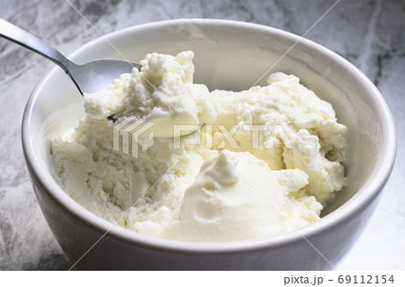 Spoon of vanilla ice cream. Seletive focus. 69112154