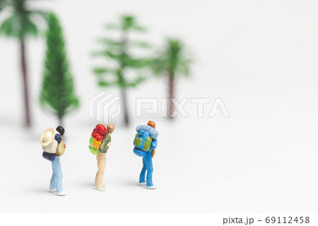 Miniature people : Traveler with backpack walking on whitebackground , Travel and Adventure concepts. 69112458