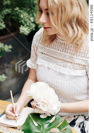 Woman filling gratitude journal Woman filling gratitude journal 69114086