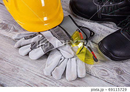 A helmet and safety shoes are essential personal accessories for every employee in the profession of a builder. 69115729