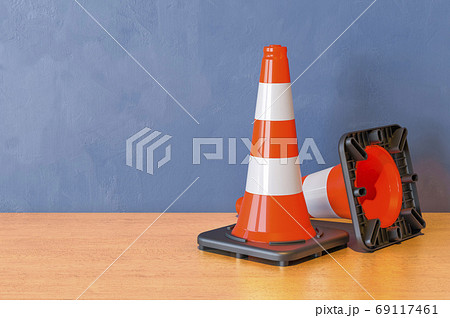 Two Road Cones on the wooden table. 3D rendering Two Road Cones on the wooden table. 3D rendering 69117461