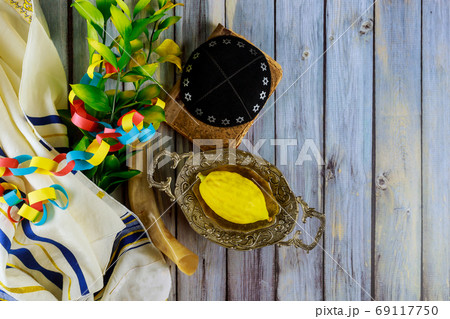 Ritual Jewish festival of Sukkot in the jewish religious symbol Etrog, lulav kippah and tallit 69117750