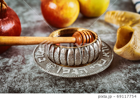 A jewish new year with honey for the apple and pomegranate holiday of Rosh Ha Shana 69117754