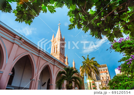 Da Nang Cathedral and beautiful tropical vegetation against the blue sky. This is one of the main architectural tourist attractions of Da Nang City. 69120554