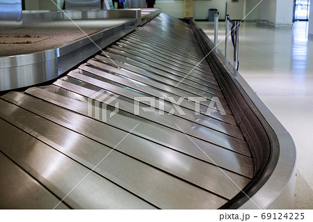 Baggage conveyor waiting for on airport after Baggage conveyor waiting for on airport after 69124225