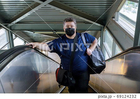 Man wear surgical face mask for protecting 69124232