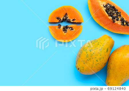 Papaya fruit on blue background. Papaya fruit on blue background. 69124840